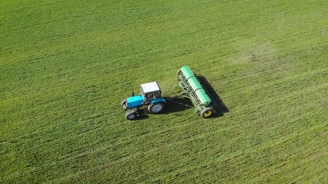 Farmer on tractor with natural eko fertilizer with manure processes field. Spring agronomic activity on agricultural land