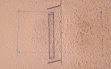 Aerial view of beach volleyball court on sand. Empty field with shadow pattern.