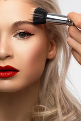 Half a beauty portrait with beautiful fashionable evening make-up, black smoky eyes and extremely long eyelashes. red lipstick on the lips. Cosmetology and spa facial skin care
