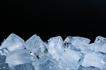 Ice cubes on black background, closeup view