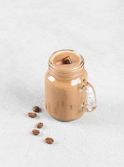 Cold drink coffee milk with ice in a jar 
