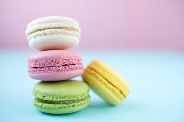 Fototapeta na wymiar Colorful macarons on pink and blue background