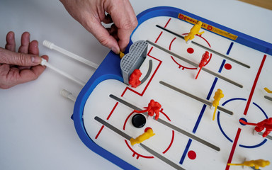 Top view of mini table ice hockey. The concept of entertainment and attracting people to sports and active lifestyles. Home entertainmentin quarantine for Coronavirus