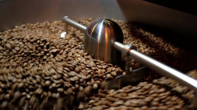 Closeup Selective focus coffee roaster with coffee beans.