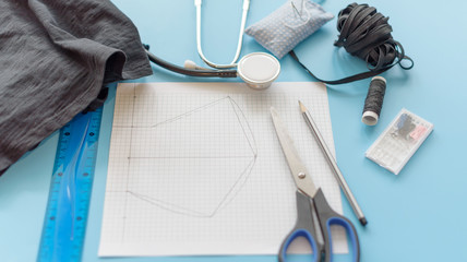 how to make a protective face mask at home from fabric, creating a markup pattern for sewing a mask, step-by-step instructions, step 1