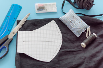 how to make a protective face mask at home from fabric, creating a markup pattern for sewing a mask, step-by-step instructions, step 2