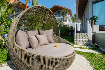 Exterior design of villa, house and home feature round shape sun bed and cushion by swimming pool