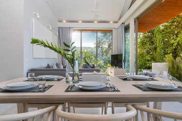 Interior design in pool villa, house and home feature dining table and dining chair in dining room with pool view