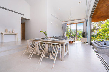 Interior design in pool villa, house and home feature dining table and dining chair in dining room with pool view