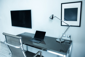 Laptop screen on desk, working space, interior of woking room, work from home