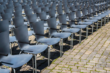 Empty chairs in rows. Open-air theater seats