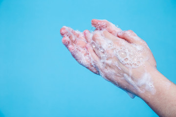 the girl washes her hands with soap. disease prevention. the concept of fighting the virus with clean hands. coronavirus