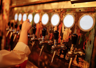 Fototapeta na wymiar Beer is poured in the bar