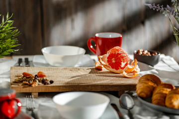 Breakfast on a wooden table in the light of the morning sun on a beautiful holiday day