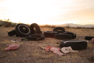 old worn out tires left to rot in a trash pile