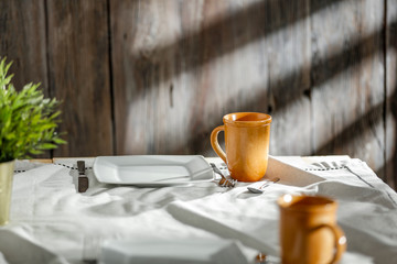 Breakfast on a wooden table in the light of the morning sun on a beautiful holiday day