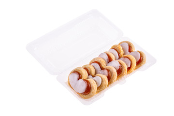 Sand cookies with jam and white glaze in plastic packaging
