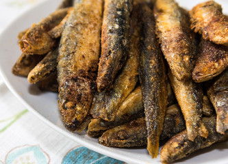 Delicious fried sardines on a plate.