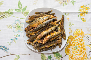 Delicious fried sardines on a plate.