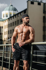 Obraz premium Sexy athlete sucks and poses topless. Europe.