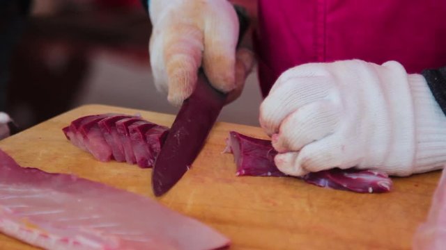 Experienced Fisherman Slicing Fish in Fish Market to cook sashimi, Jeju-Island
