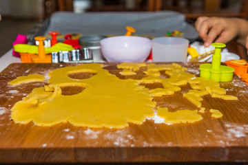 Young children playing with coockie dough, making cookies with models.
