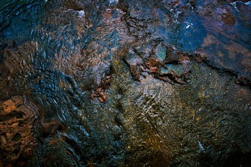 Dramatic, colorful and vivid water surface at the Iguazu Falls. Deeply detailed texture in shiny coral colors.