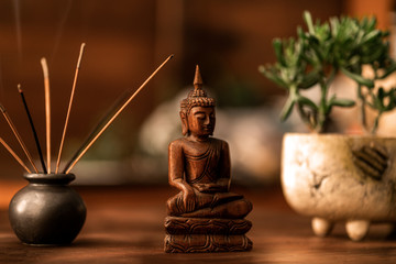 Buddha figurine wood table and background. Homemade meditation.Spiritual. Relaxation. Asia religion