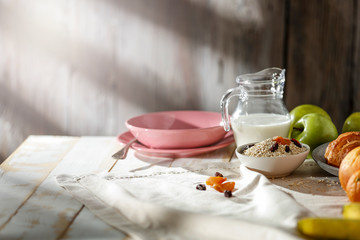 Breakfast on a wooden table in the light of the morning sun on a beautiful holiday day