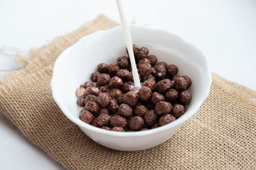 Chocolate balls with milk in a white plate
