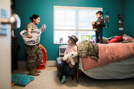 Soldier mother and children in bedroom