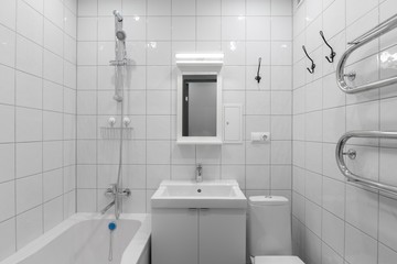 minimalist white bathroom with mirror