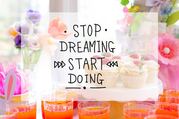 Stop dreaming start doing message with dessert table with cupcakes and flowers