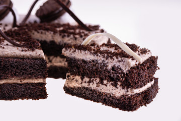 Piece of chocolate cake with oreo cookies and chocolate crumb