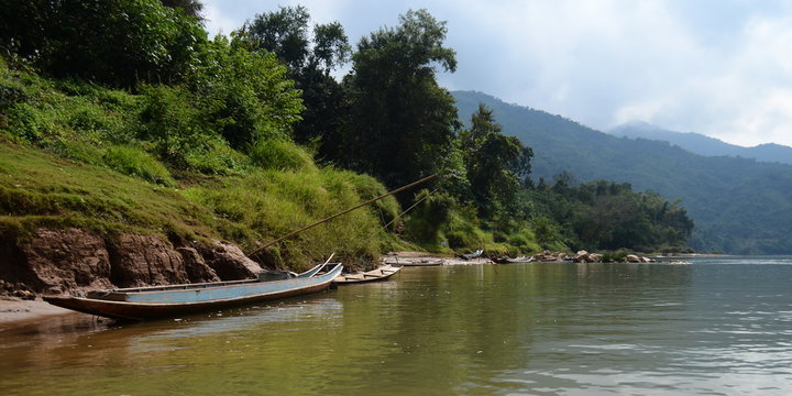 Beautiful image of a traditional wooden boat at the Nam On River