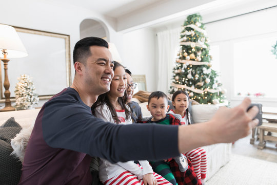 Father taking selfie with children on Christmas morning