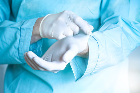 Doctor putting on sterile gloves. Close up concept. Virus. Testing covid 19
