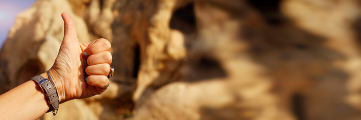 Women thumb up on the background of pyramids of Cappadocia
