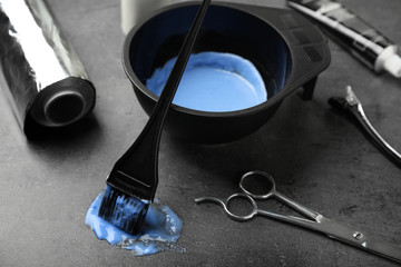 Professional tools for hair dyeing on grey stone background