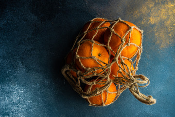 Ripe organic oranges on dark wooden background