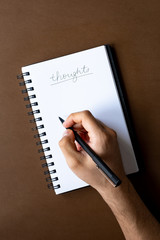 Notebook with Thoughts and Pen in Hand