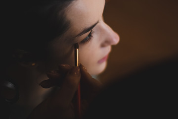 Obraz premium girl preparing for the holiday, woman doing makeup at home