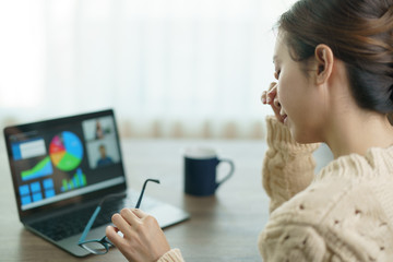 Woman using laptop making video call to partner, looking at screen with conference. work from home.