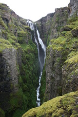 Glymur cascade falling a mossy canyon in Iceland