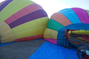 Fototapeta premium The atmosphere oat the balloon festival was fun and exciting to watch as the team members worked together to fill and launch the balloons.
