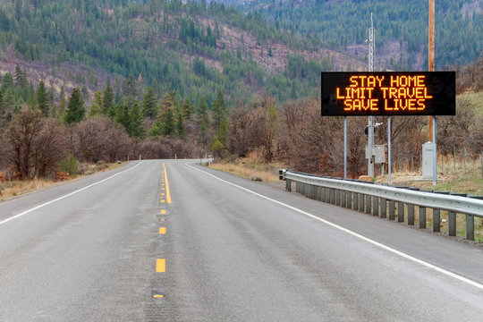 Electronic sign along U.S. Highway 97 in Washington state notifying people to stay home, limit travel and save lives by reducing the risk of being infected due to COVID-19