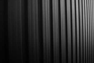 Black Corrugated metal sheet surface of the wall. Galvanize steel background.