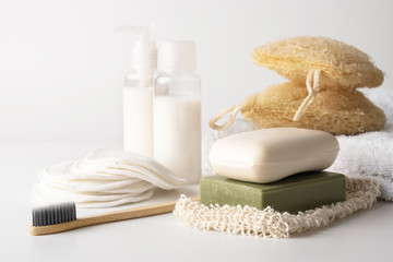 Obraz na płótnie Canvas Zero waste, sustainable bathroom and lifestyle. Bamboo toothbrush, natural soap bar, loofah sponge, cotton pads, homemade DIY beauty products in reusable bottles