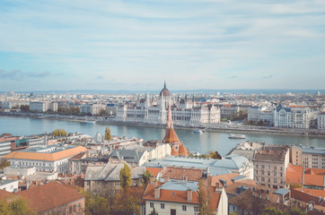 Cityscape of Budapest, Hungary. Hungarian Parliament Building, Orszaghaz, in the far background on the other side of the Danube river. Horizontal photo with a vintage filter
