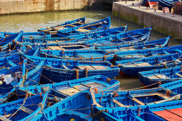Fototapeta na wymiar Lots of blue fishing boats in the port of Essaouira